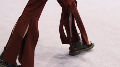 Woman Model in Torn Dark Red Jeans and Boots Walks on Vogue Fashion Show Runway