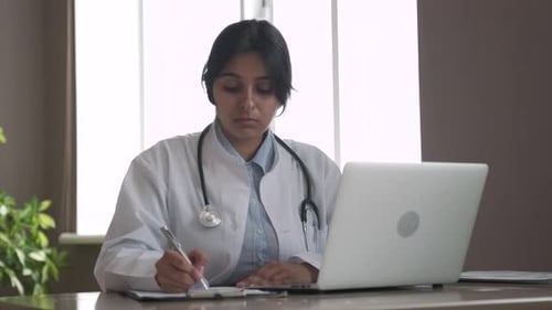 Female Doctor Consults Patient Over Laptop