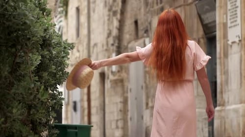 Happy Woman Tourist Laughs and Whirls on Street of Old European City