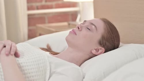 Woman Sleeping Peacefully in White Bedding
