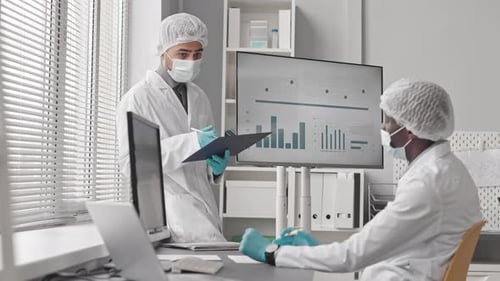 Medical Professionals Analyzing Data in Bright Office
