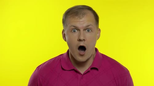 Man Reacting with Surprise Against Yellow Background