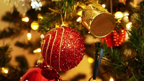 Christmas Ornaments Twinkling on Decorated Evergreen Tree