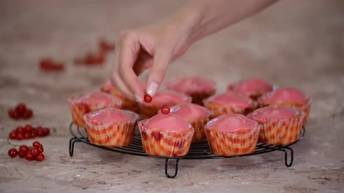 Garnishing Cupcakes with Currants in Kitchen, Close Up