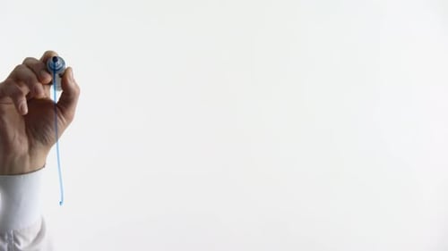 Hand Writes 'Revenue' with Blue Marker on Clear Surface