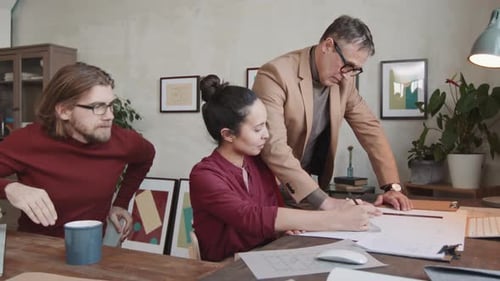 Team Collaborate on Architecture Plans in Office