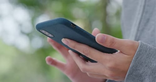 Woman Use of Smart Phone at The Park