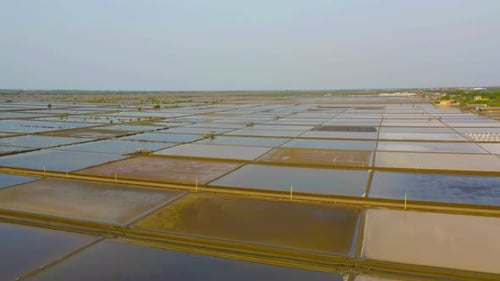 Aerial top view of natural sea salt ponds. Farm field outdoor. Material in traditional industry
