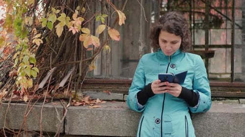 Woman Looks Phone