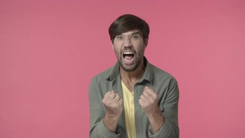 Furious Man Yelling with Clenched Fists