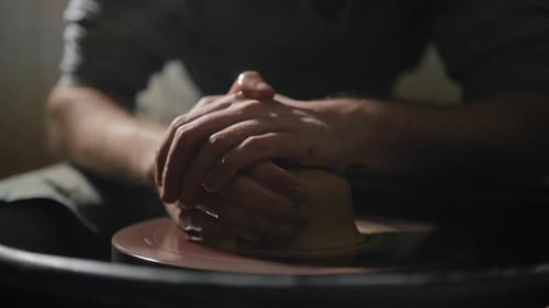 Hands Shaping Clay on Pottery Wheel