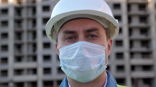 Construction Worker Wearing Hardhat and Protective Face Mask