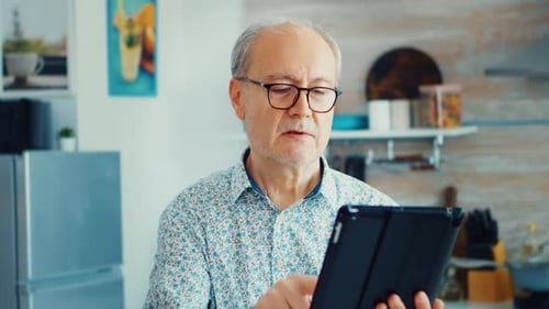 Senior Man Using Tablet in Kitchen Close Up