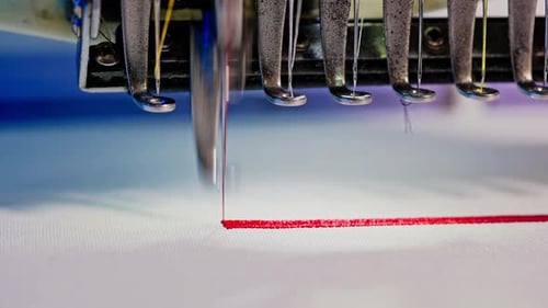 Embroidery Machine Stitching Red Thread on White Canvas