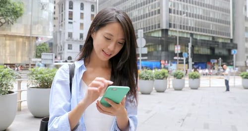 Woman Using Smartphone in an Urban Setting