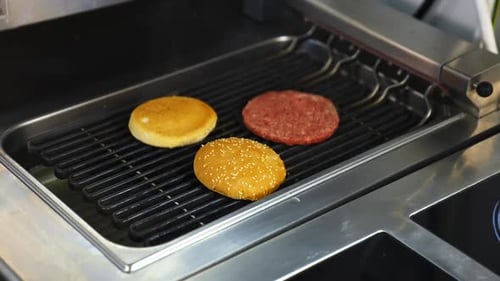 Burger Buns and Patty on Commercial Restaurant Grill