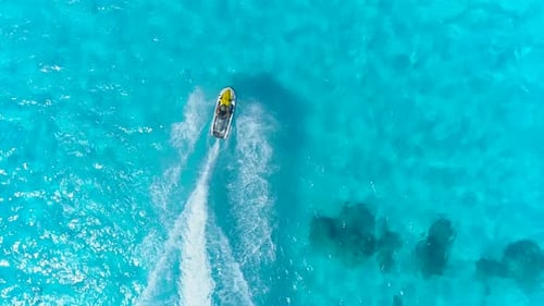 Aerial drone view of jetski personal watercraft in Bora Bora tropical island.
