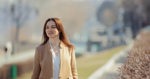 Young Pretty Woman Walks Down the Street and Enjoys Life