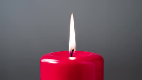 Burning Bright Red Candle Flame Close Up