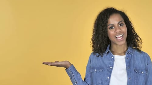 Smiling Woman Gesturing to the Left