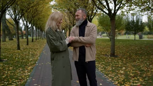 Side View of Happy Smiling Lovers Talking in Fall Park