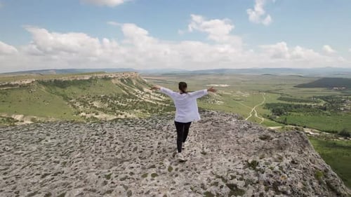 The Girl Approaches the Edge of the Cliff Shooting From a Drone