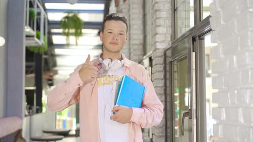 Smiling male student in cafe.