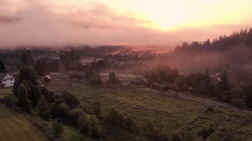 Mist Shrouded Village at Sunrise Aerial View