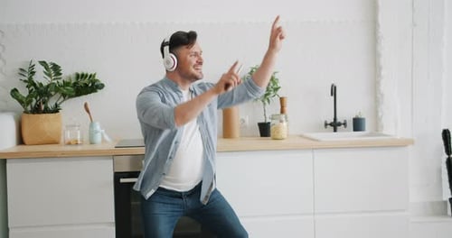Man Listening to Music, Dancing in Kitchen