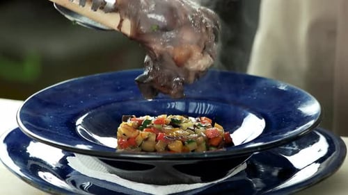 Chef Plates Lamb Shank with Diced Vegetables