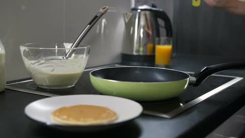 Person Cooking a Pancake in the Kitchen