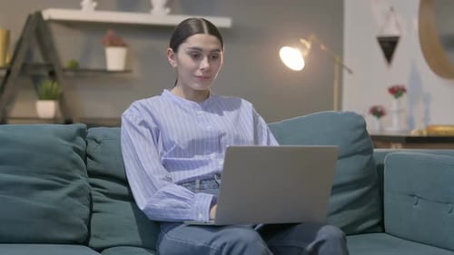 Excited Woman Working on Laptop at Home