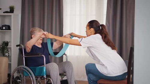 Senior Woman Exercising with Therapist Using Resistance Band