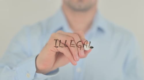 Man Writes Word Illegal on Clear Surface
