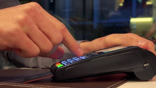Person Using Credit Card at a Card Reader