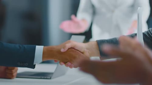 Business Handshake Agreement with Clapping in Background