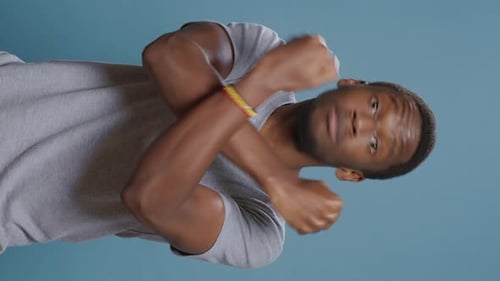 Young Adult Man Crossing Arms in Studio