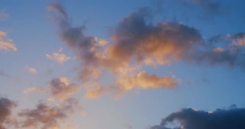 Golden Clouds Drifting in Stunning Sunset Sky