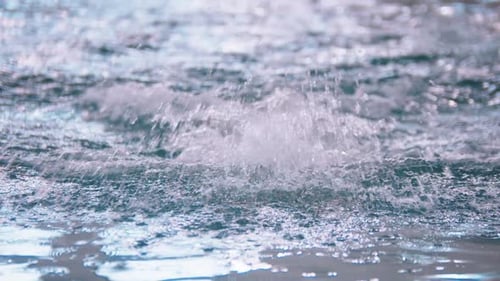 A Man in Yellow Cap Swimming on the Track in the Pool