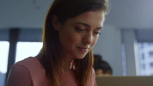 Woman Uses Smartphone in Modern Office