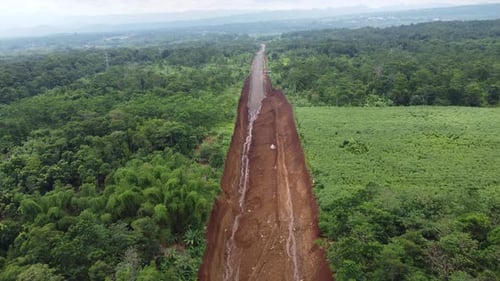 Land clearing for the highway from aerial drone footage of forward motion