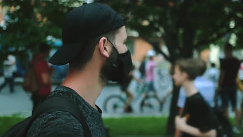 Young Adult Wearing Face Mask in Urban Crowd
