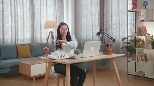 Woman Works at Laptop, Stretches in Home Office