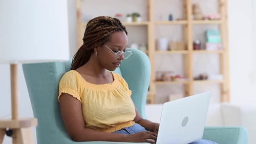 Woman Works on Laptop in Bright Living Room