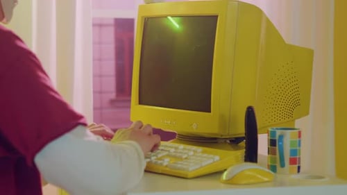 Retro Yellow Computer on Desk with Remote Control