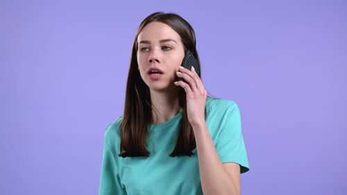 Young Woman Talking on Mobile Phone, Turquoise T-Shirt
