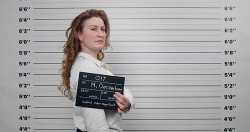 Woman Holding Placard at Height Chart Backdrop
