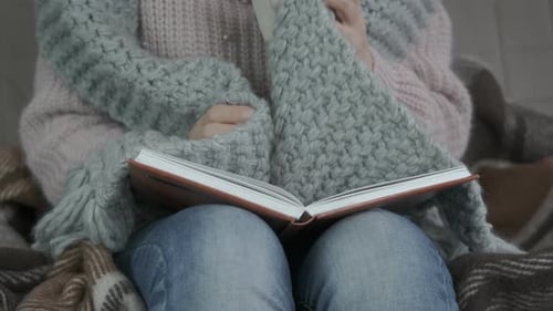 Woman Reading and Drinking Tea Cozy Indoors
