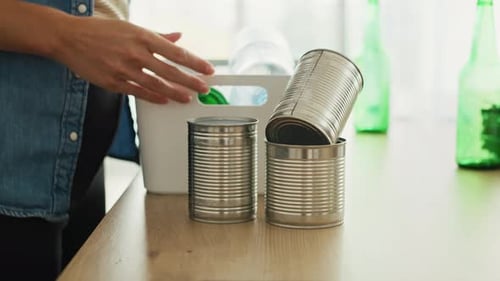 Woman Recycling Items into Bin at Home