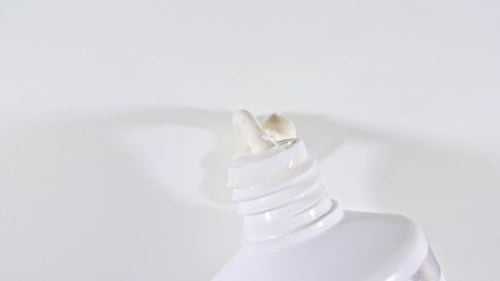 Extruding White Cream from a Tube, Close-up